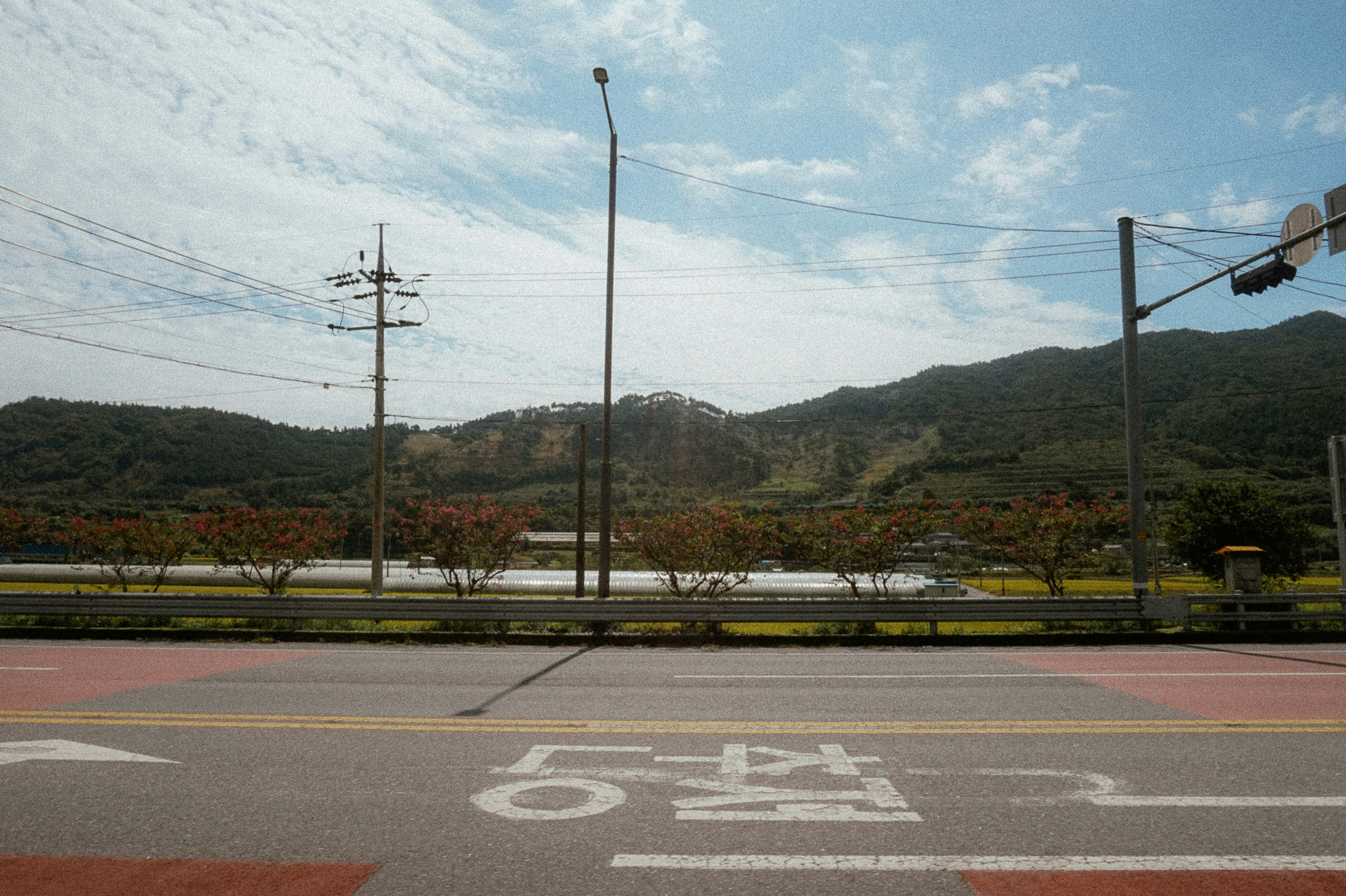 An empty street with a bicycle lane on the side